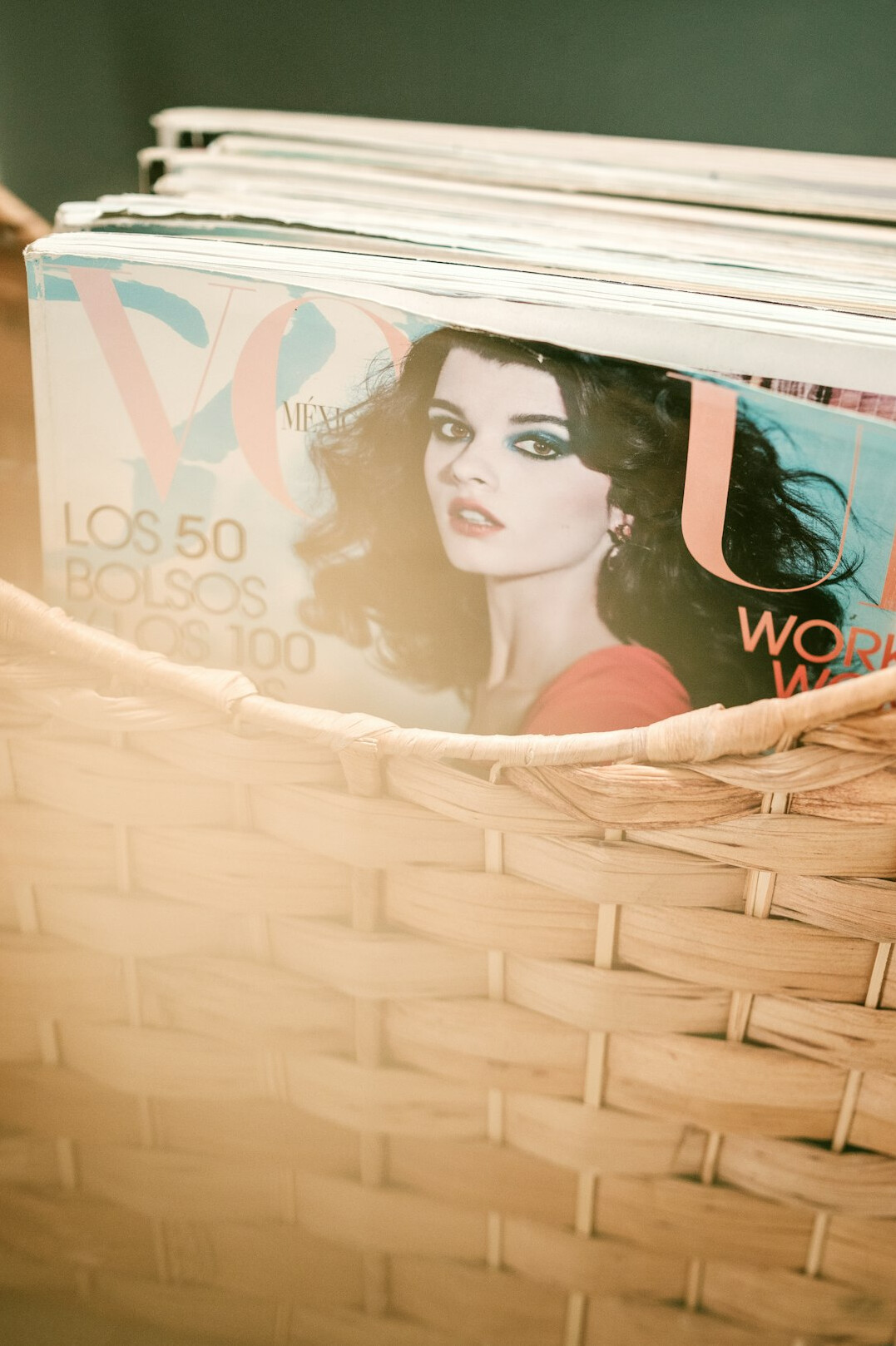 Stack of vintage magazines and advertising archive folders on a wooden table